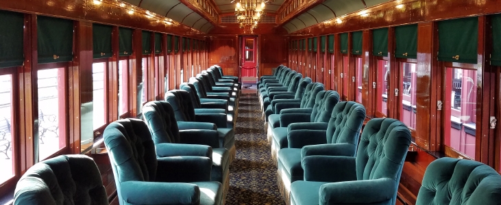 The Linn W. Moedinger train car with two rows of comfy armchairs.