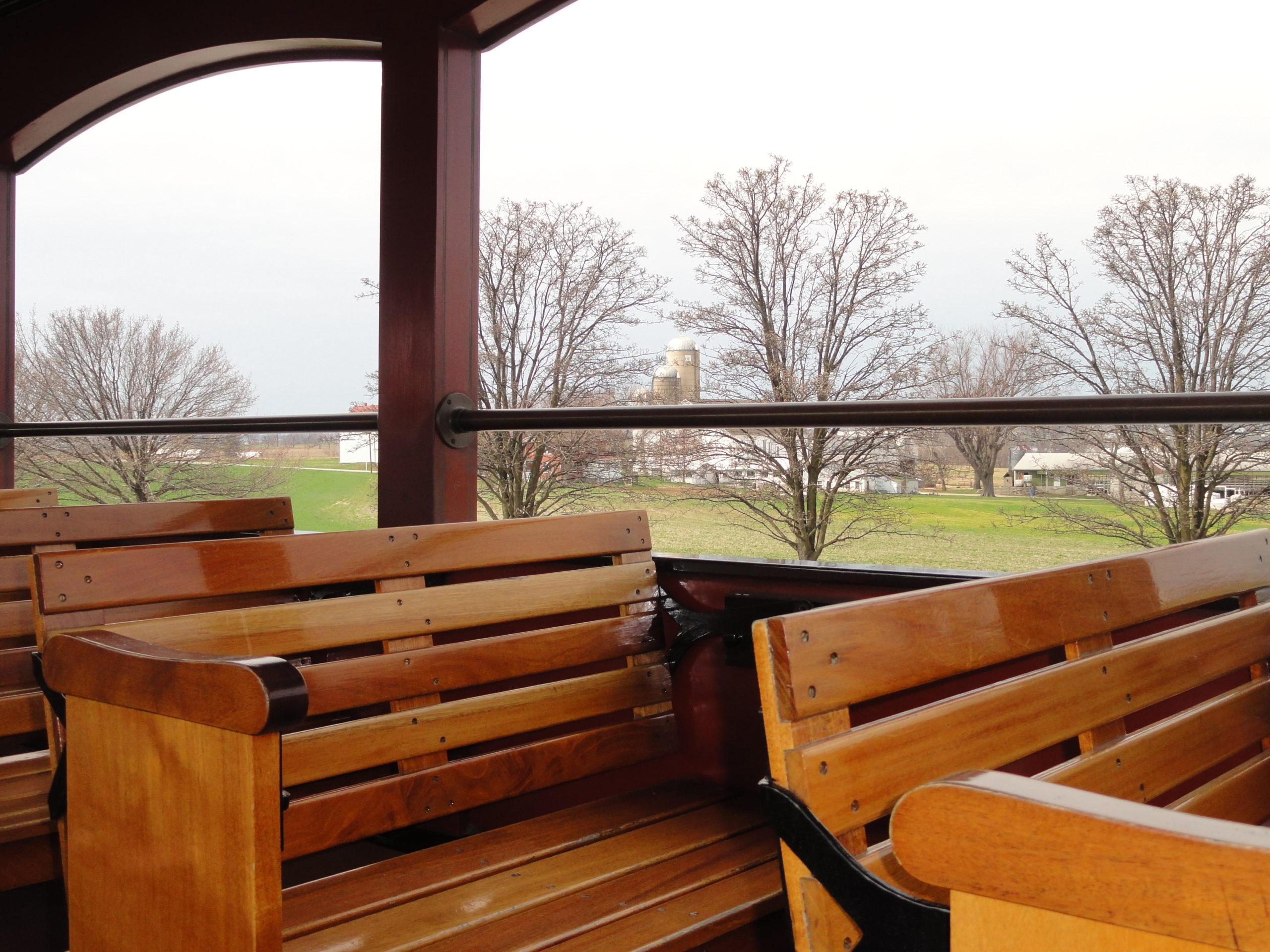 Hard wooden bench seats on the Open Air Car on a train.