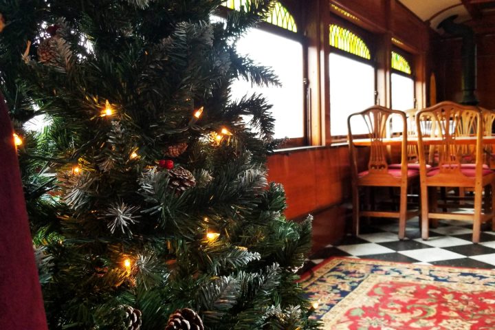 The inside of the club car at Strasburg Rail Road during Christmastime.