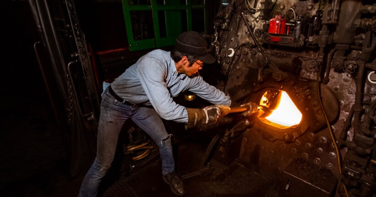 A fireman working on a steam train.