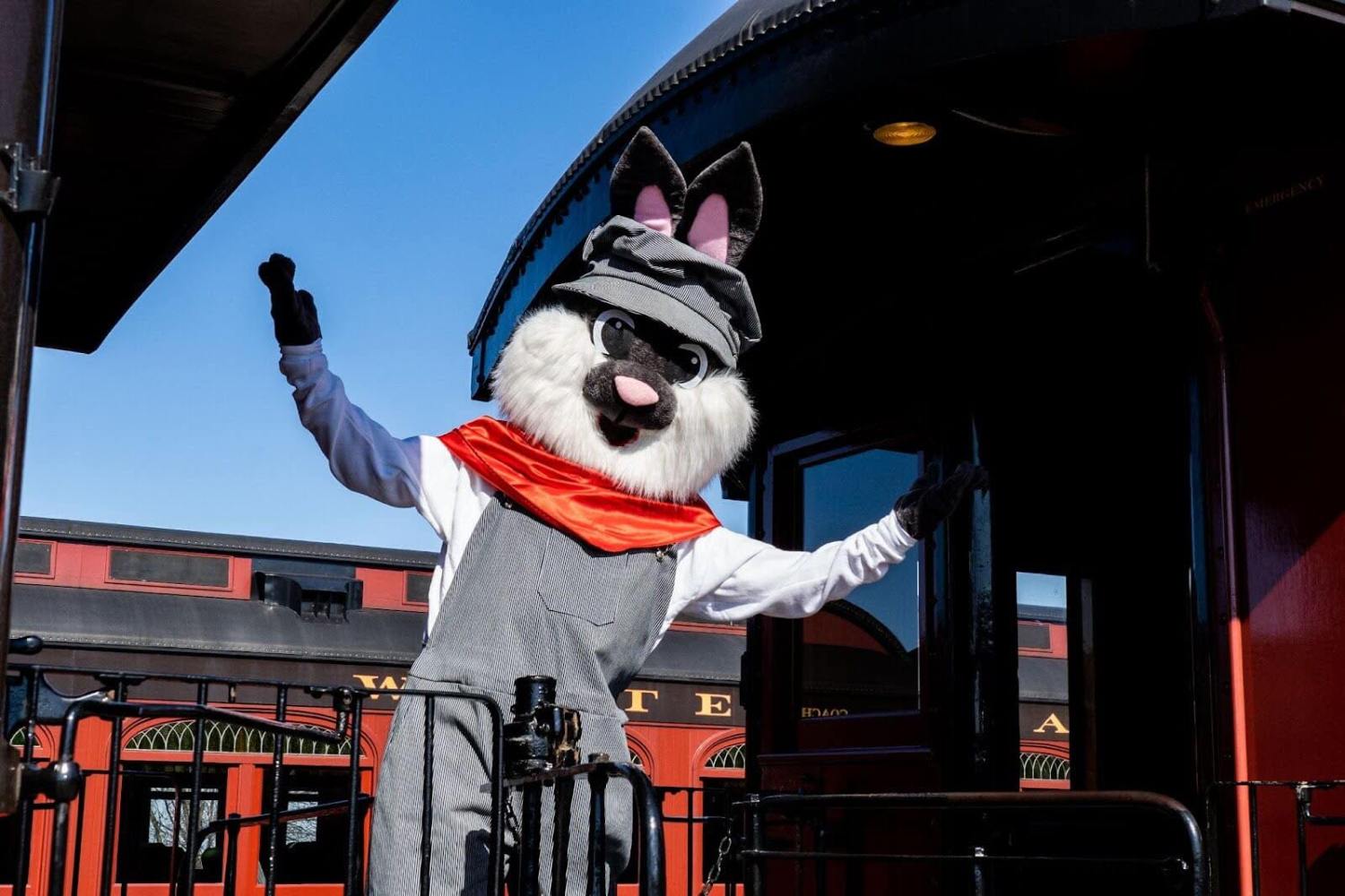 the easter bunny standing and waving from the caboose of the train