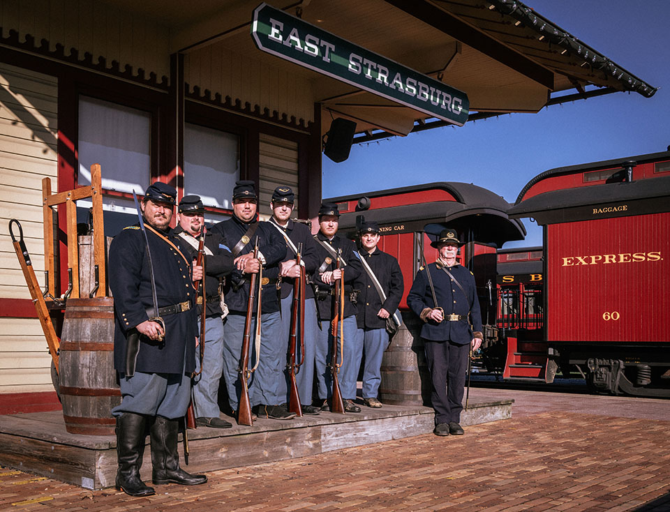 A group of officers in uniform standing in front of East Strasburg Station.