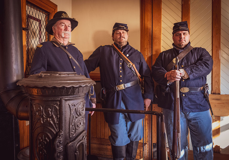 Three officers in uniform standing in a room.