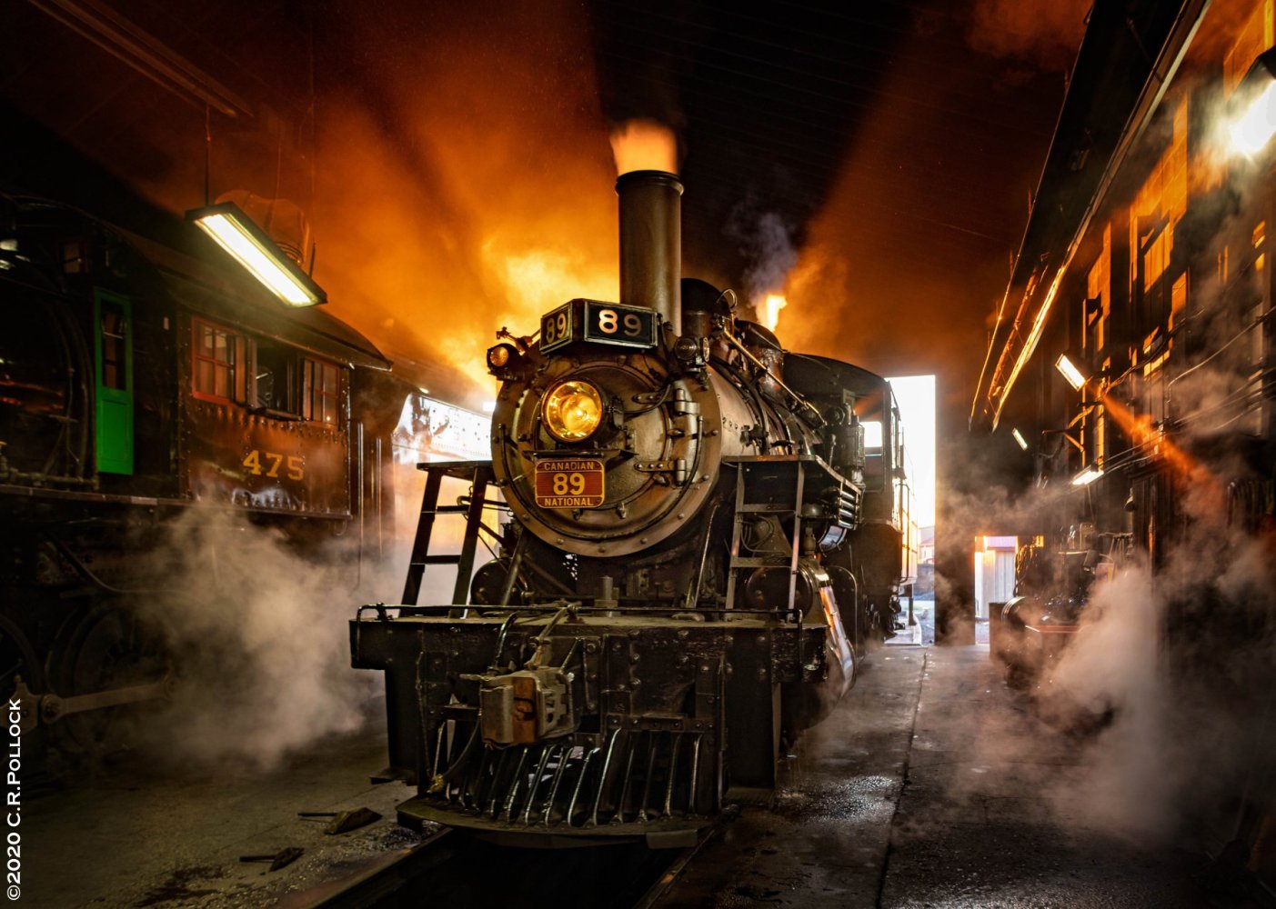 a steam train on a track with smoke coming out of it