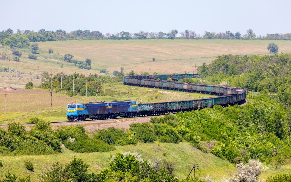 A far shot of a train traveling across miles of open land.